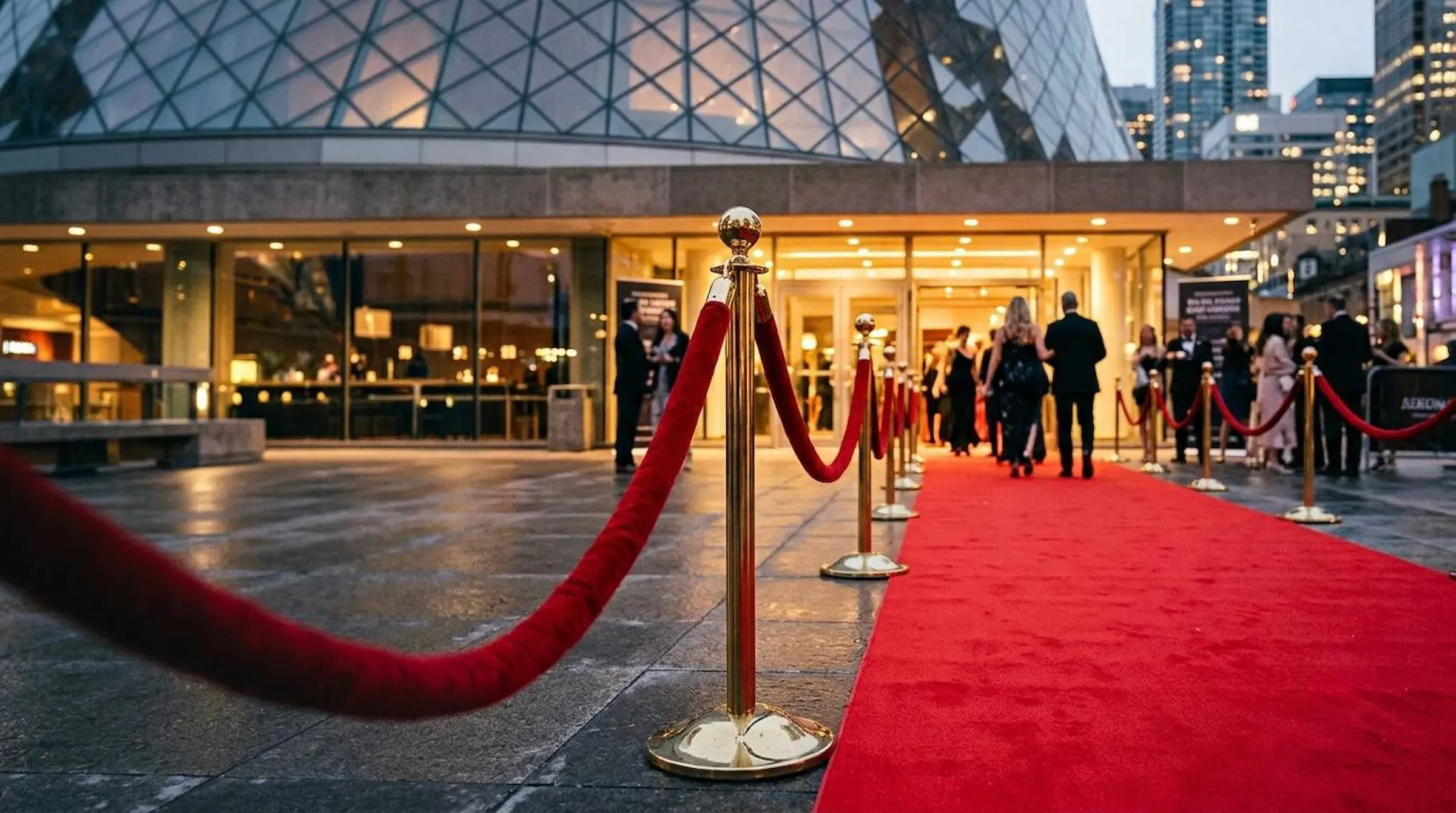 Rope stanchions and a red carpet runner at an event entrance